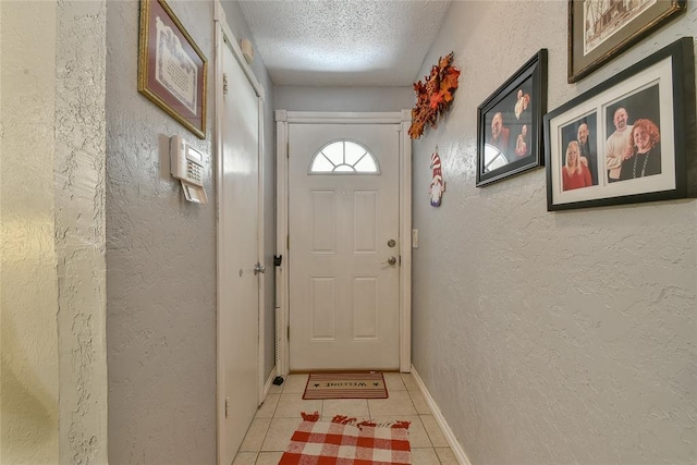 5505 S Dimple Dr, Oklahoma City, OK 73135 - entryway with light tile patterned floors, a textured ceiling, and a textured wall