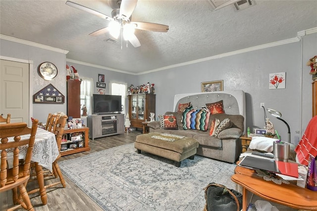 5505 S Dimple Dr, Oklahoma City, OK 73135 - living room featuring wood finished floors, ceiling fan, a textured ceiling, and ornamental molding