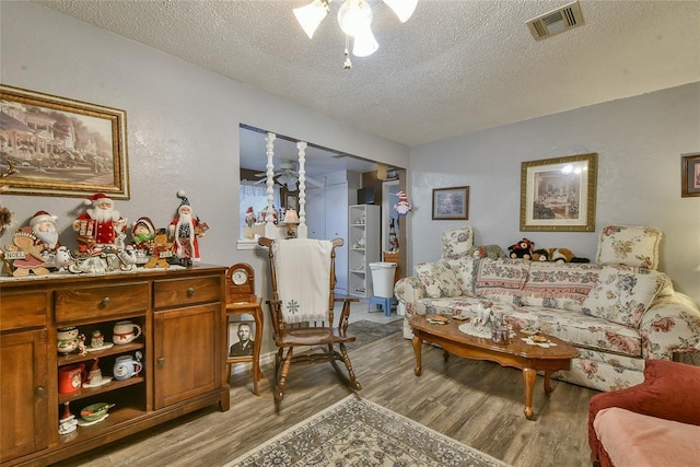 5505 S Dimple Dr, Oklahoma City, OK 73135 - living area featuring light wood-style flooring, a textured ceiling, and a ceiling fan