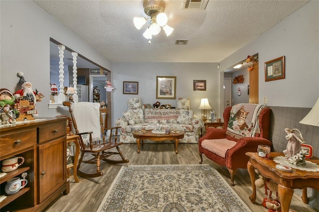 5505 S Dimple Dr, Oklahoma City, OK 73135 - living area with light wood-type flooring, a textured ceiling, and ceiling fan