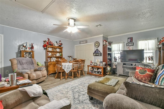 5505 S Dimple Dr, Oklahoma City, OK 73135 - living area featuring a textured ceiling, wood finished floors, ceiling fan, and crown molding
