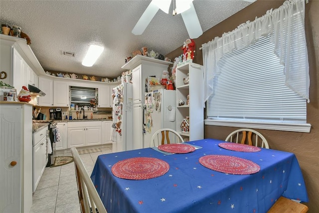 5505 S Dimple Dr, Oklahoma City, OK 73135 - dining room featuring a textured ceiling, light tile patterned floors, and a ceiling fan