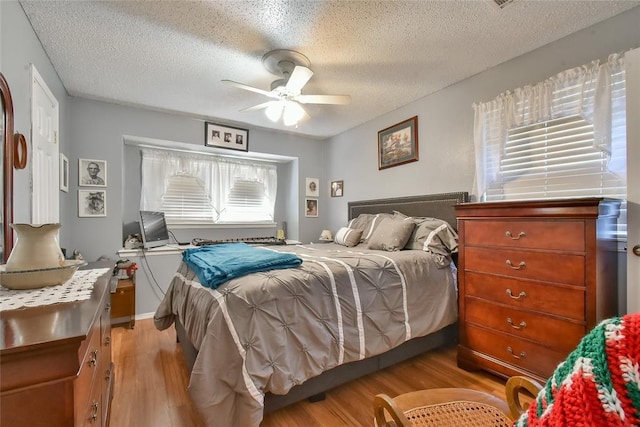 5505 S Dimple Dr, Oklahoma City, OK 73135 - bedroom with light wood-style floors, a textured ceiling, and ceiling fan
