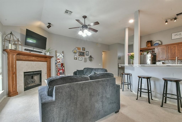 4616 Midway Dr, Norman, OK 73072 - living area with light carpet, ceiling fan, a fireplace, and vaulted ceiling