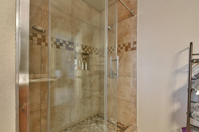 4616 Midway Dr, Norman, OK 73072 - full bathroom with a stall shower and a textured wall