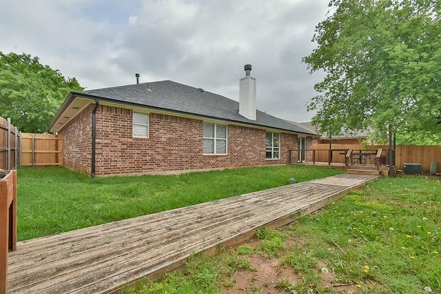 4616 Midway Dr, Norman, OK 73072 - rear view of house featuring a wooden deck, a fenced backyard, a chimney, and brick siding