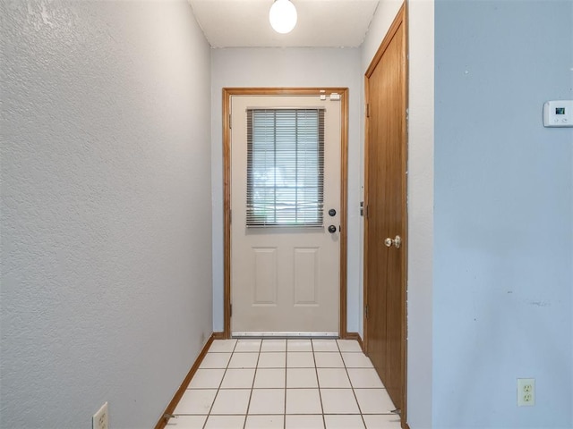 321 Bradgate Dr, Yukon, OK 73099 - doorway to outside with a textured wall and baseboards