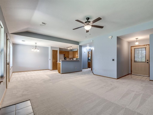 321 Bradgate Dr, Yukon, OK 73099 - unfurnished living room featuring light colored carpet, a ceiling fan, a chandelier, and lofted ceiling