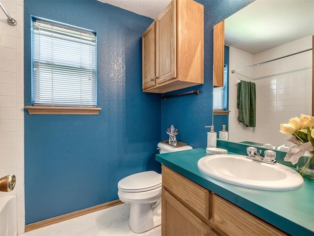 321 Bradgate Dr, Yukon, OK 73099 - bathroom featuring vanity, shower / tub combo with curtain, and a textured wall