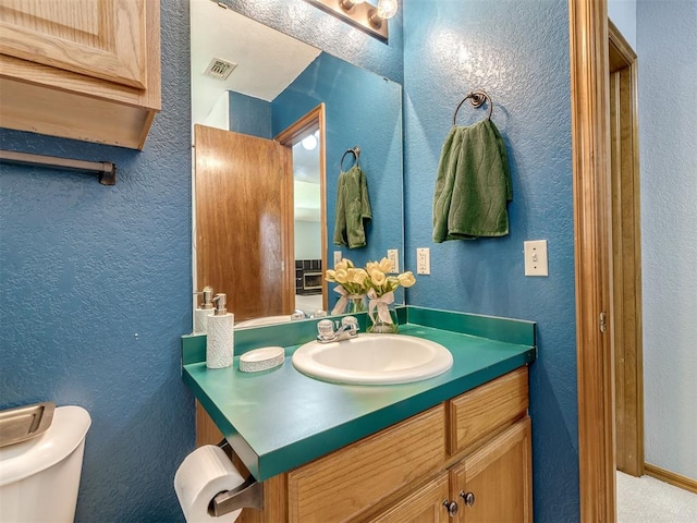 321 Bradgate Dr, Yukon, OK 73099 - bathroom with vanity and a textured wall