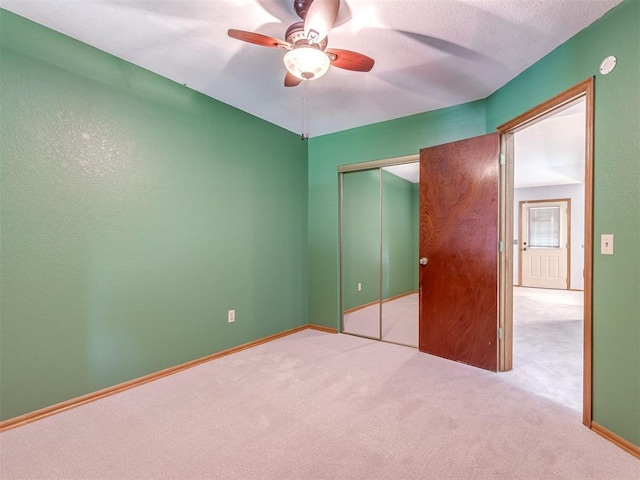 321 Bradgate Dr, Yukon, OK 73099 - unfurnished bedroom with carpet, a closet, and a ceiling fan