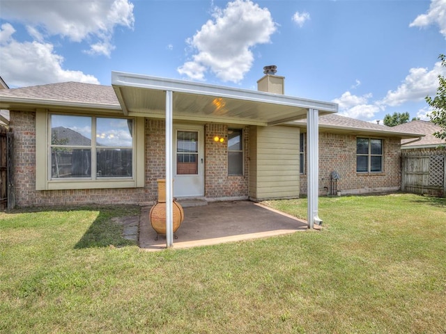 321 Bradgate Dr, Yukon, OK 73099 - rear view of property with a patio, a chimney, brick siding, and roof with shingles
