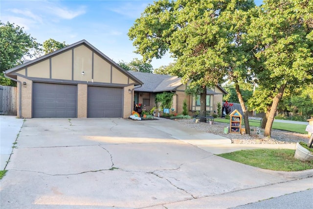 4213 NE 143rd St, Edmond, OK 73013 - view of front facade featuring a garage, driveway, and brick siding