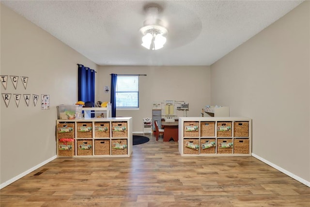 4213 NE 143rd St, Edmond, OK 73013 - office space featuring a ceiling fan, wood finished floors, and a textured ceiling