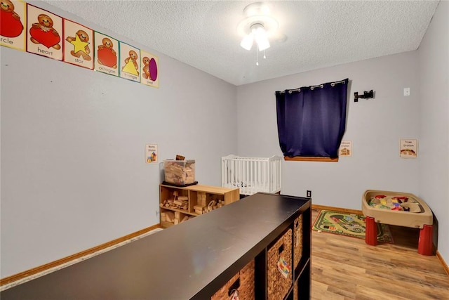 4213 NE 143rd St, Edmond, OK 73013 - bedroom featuring wood finished floors and a textured ceiling