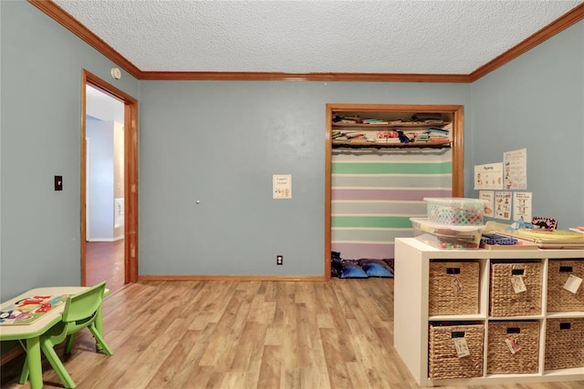4213 NE 143rd St, Edmond, OK 73013 - game room with ornamental molding, wood finished floors, and a textured ceiling