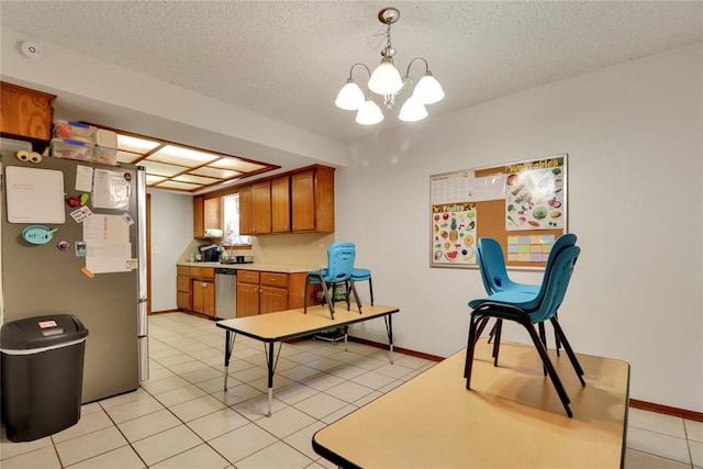 4213 NE 143rd St, Edmond, OK 73013 - kitchen featuring stainless steel appliances, brown cabinets, light countertops, a chandelier, and a textured ceiling