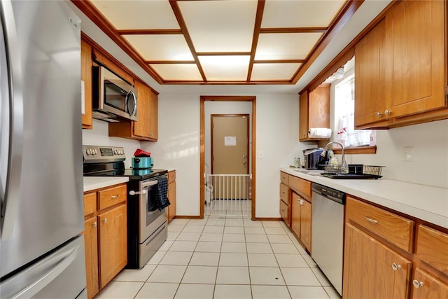 4213 NE 143rd St, Edmond, OK 73013 - kitchen with stainless steel appliances, light countertops, and brown cabinets