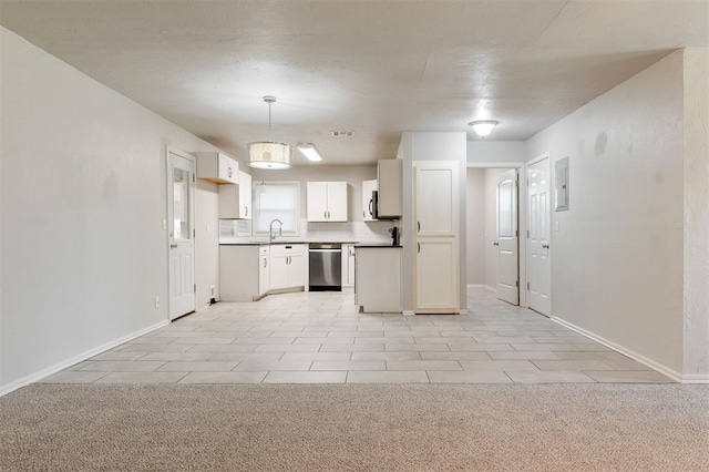 300 Yukon Ave, Yukon, OK 73099 - kitchen featuring stainless steel dishwasher, white cabinets, pendant lighting, and open floor plan