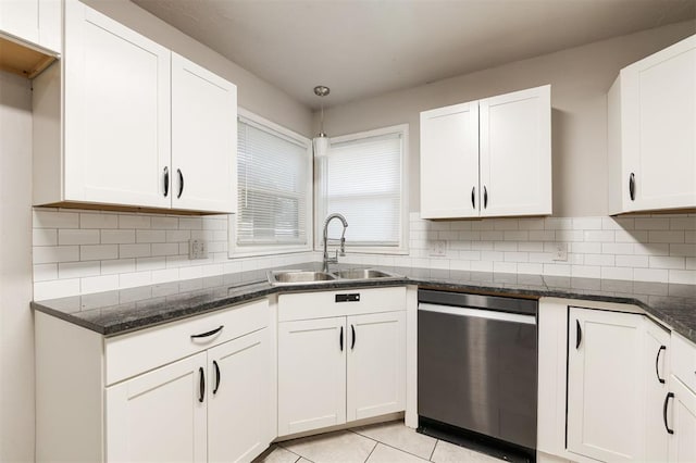 300 Yukon Ave, Yukon, OK 73099 - kitchen featuring stainless steel dishwasher, white cabinetry, decorative backsplash, and dark stone counters