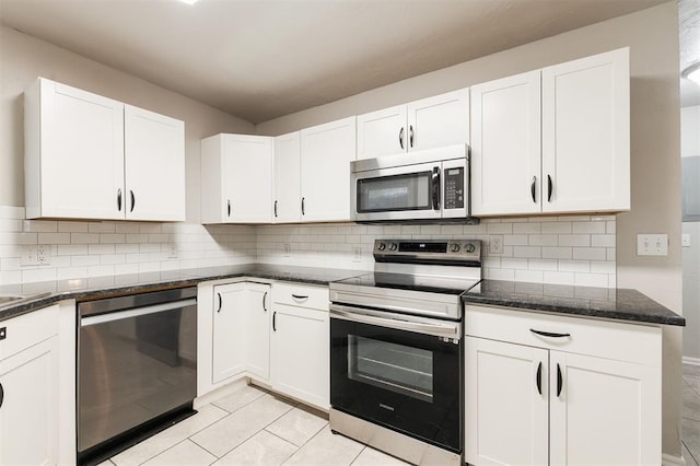 300 Yukon Ave, Yukon, OK 73099 - kitchen featuring appliances with stainless steel finishes, white cabinetry, dark stone countertops, and backsplash