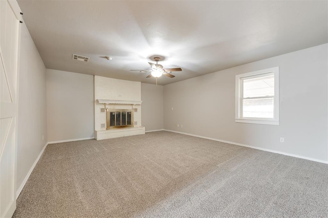 300 Yukon Ave, Yukon, OK 73099 - unfurnished living room featuring ceiling fan, light carpet, and a glass covered fireplace
