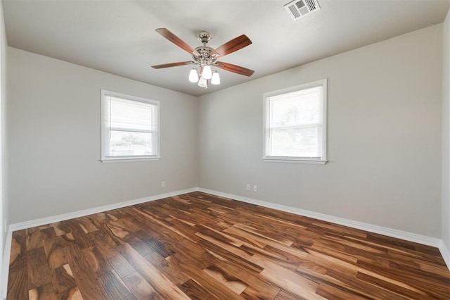 300 Yukon Ave, Yukon, OK 73099 - unfurnished room featuring plenty of natural light, dark wood-style floors, and a ceiling fan