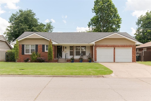 2800 Kerry Ln, Oklahoma City, OK 73120 - ranch-style house featuring brick siding, an attached garage, a porch, concrete driveway, and a front lawn