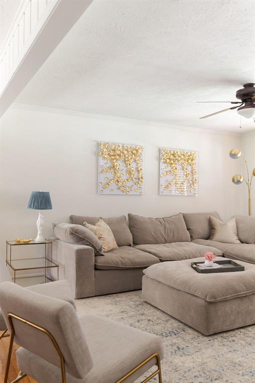 2800 Kerry Ln, Oklahoma City, OK 73120 - living room with a ceiling fan, a textured ceiling, and ornamental molding