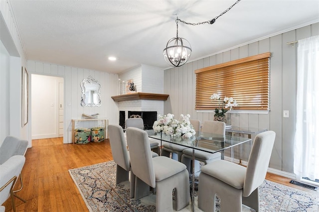 2800 Kerry Ln, Oklahoma City, OK 73120 - dining area featuring a chandelier, wood finished floors, and a fireplace