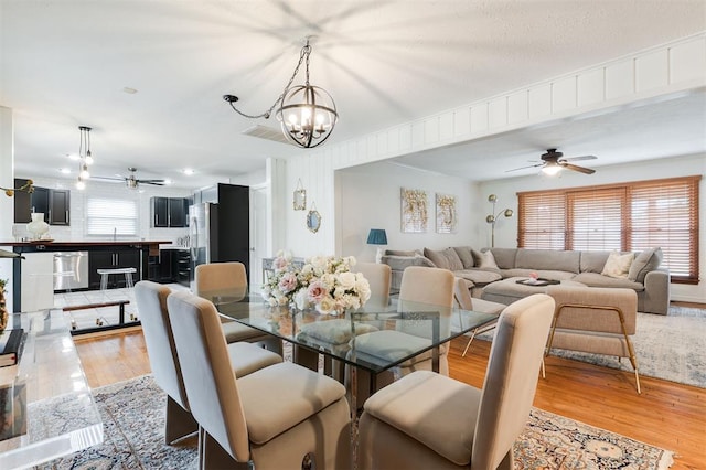 2800 Kerry Ln, Oklahoma City, OK 73120 - dining room with a ceiling fan, a chandelier, and light wood-type flooring