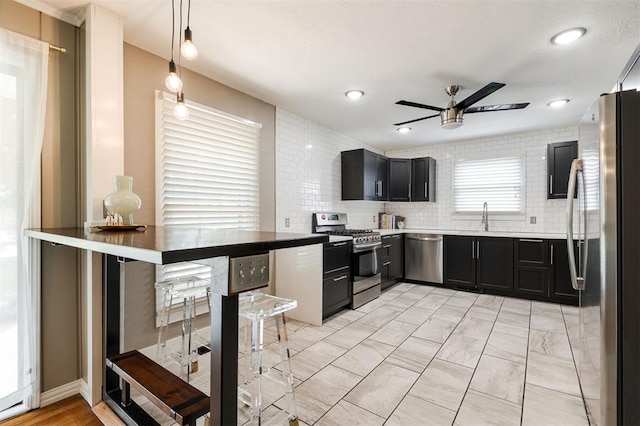 2800 Kerry Ln, Oklahoma City, OK 73120 - kitchen with appliances with stainless steel finishes, a ceiling fan, dark cabinets, decorative light fixtures, and recessed lighting