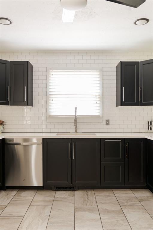 2800 Kerry Ln, Oklahoma City, OK 73120 - kitchen with stainless steel dishwasher, tasteful backsplash, light countertops, and dark cabinets