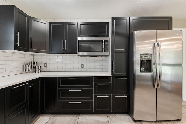 2800 Kerry Ln, Oklahoma City, OK 73120 - kitchen featuring appliances with stainless steel finishes, dark cabinets, light countertops, and tasteful backsplash