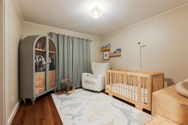 2800 Kerry Ln, Oklahoma City, OK 73120 - bedroom featuring wood finished floors, a nursery area, crown molding, and a textured ceiling