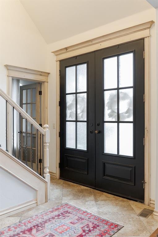 3101 White Cedar Dr, Moore, OK 73160 - tiled foyer entrance featuring french doors, vaulted ceiling, stairs, and healthy amount of natural light