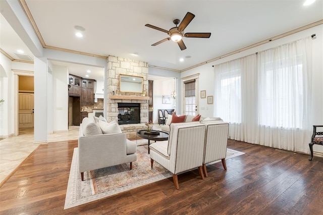 3101 White Cedar Dr, Moore, OK 73160 - living room with ceiling fan, ornamental molding, a fireplace, wood finished floors, and recessed lighting