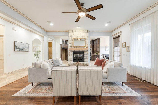 3101 White Cedar Dr, Moore, OK 73160 - living room featuring a ceiling fan, a fireplace, crown molding, wood finished floors, and recessed lighting