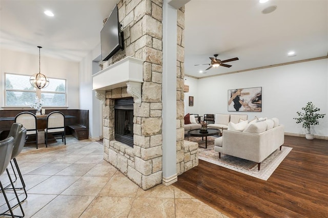 3101 White Cedar Dr, Moore, OK 73160 - living area featuring a ceiling fan, a chandelier, a fireplace, recessed lighting, and ornamental molding