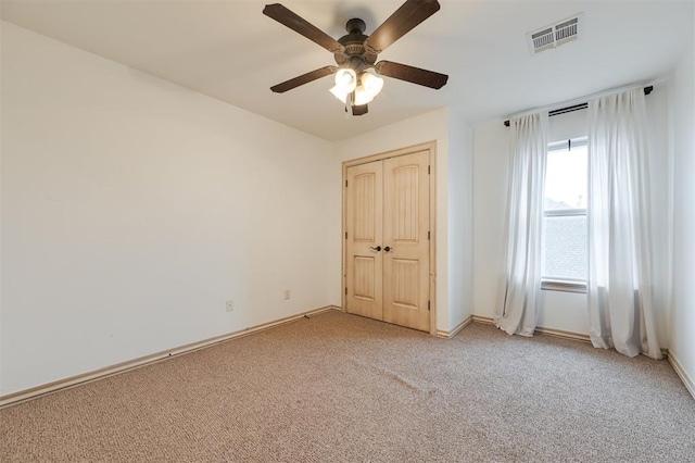 3101 White Cedar Dr, Moore, OK 73160 - unfurnished bedroom featuring light colored carpet, a closet, and ceiling fan