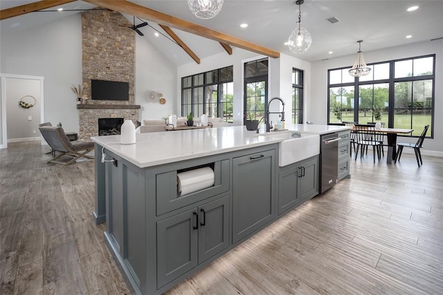 18569 310th St, Norman, OK 73072 - kitchen featuring gray cabinetry, light countertops, a kitchen island with sink, open floor plan, and beamed ceiling