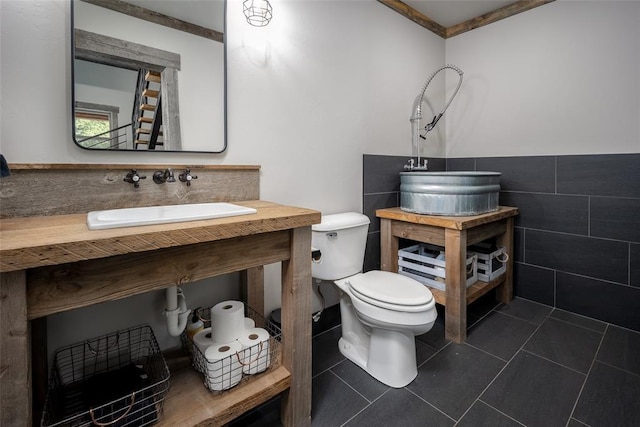 18569 310th St, Norman, OK 73072 - bathroom with tile walls, tile patterned floors, vanity, and wainscoting