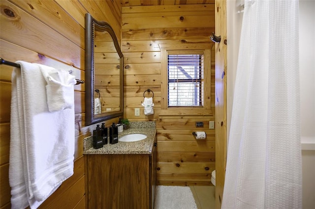 225 Stevens Rd, Broken Bow, OK 74728 - full bathroom featuring wood walls, vanity, and a shower with shower curtain