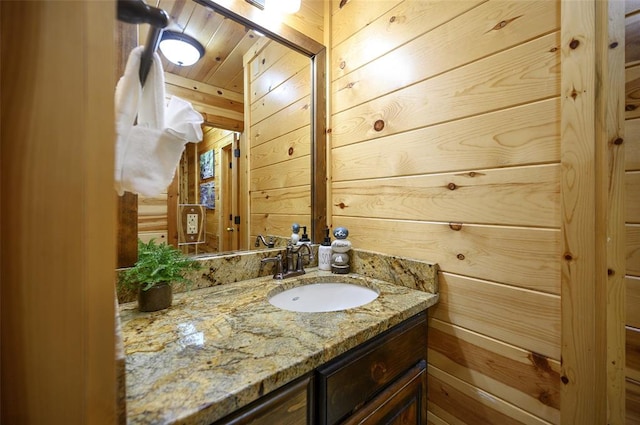 225 Stevens Rd, Broken Bow, OK 74728 - bathroom featuring wooden walls and vanity