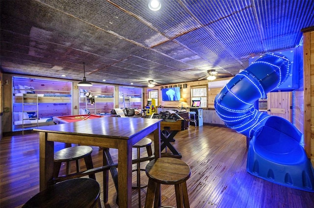 225 Stevens Rd, Broken Bow, OK 74728 - bar featuring wood finished floors, ceiling fan, and wood walls