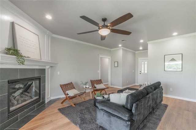 1848 County Road 1198, Tuttle, OK 73089 - living room featuring recessed lighting, ceiling fan, ornamental molding, wood finished floors, and a tile fireplace