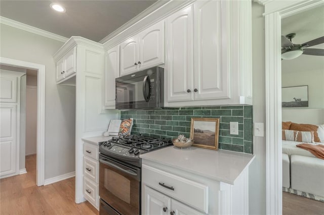 1848 County Road 1198, Tuttle, OK 73089 - kitchen with black appliances, white cabinetry, decorative backsplash, light countertops, and ornamental molding