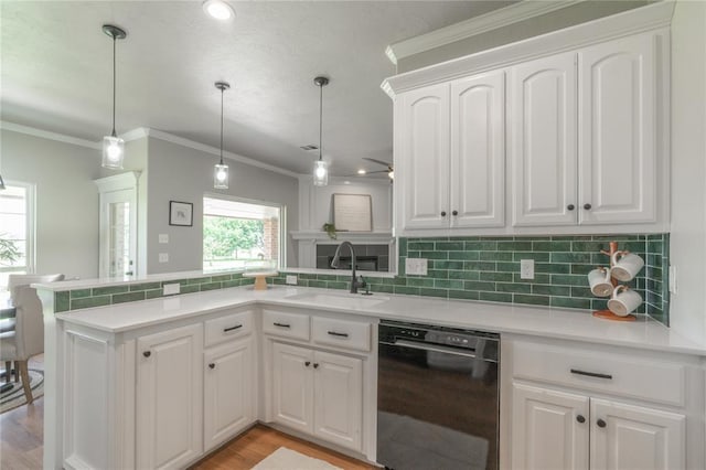 1848 County Road 1198, Tuttle, OK 73089 - kitchen with dishwasher, a peninsula, decorative backsplash, white cabinetry, and crown molding
