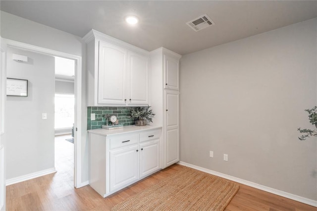 1848 County Road 1198, Tuttle, OK 73089 - kitchen with light wood-type flooring, white cabinets, light countertops, decorative backsplash, and recessed lighting