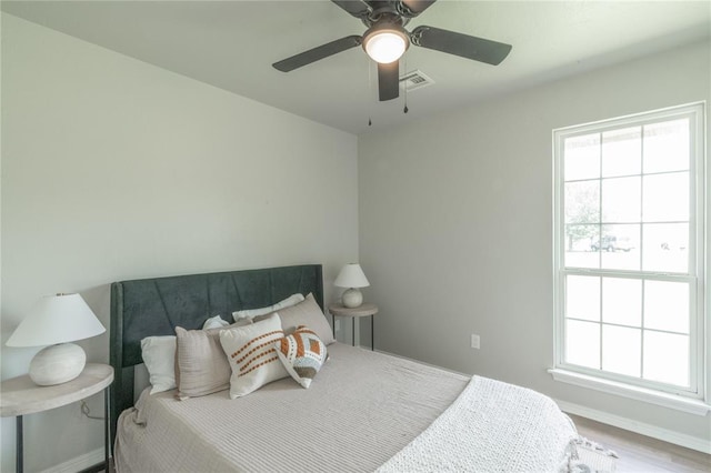 1848 County Road 1198, Tuttle, OK 73089 - bedroom with multiple windows, wood finished floors, and a ceiling fan